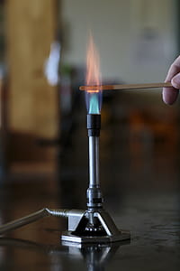 Cobalt solution burning on a wooden splint in a bunsen burner flame. thumbnail