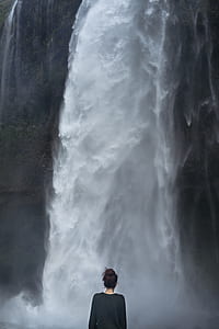 woman standing in front of waterfall thumbnail
