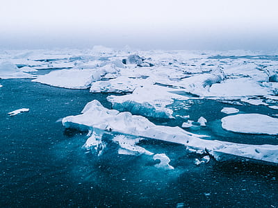 icebergs on large body of water aerial photo thumbnail