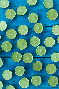 sliced lime on blue wooden board thumbnail