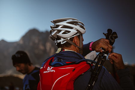 man carrying black tripod thumbnail