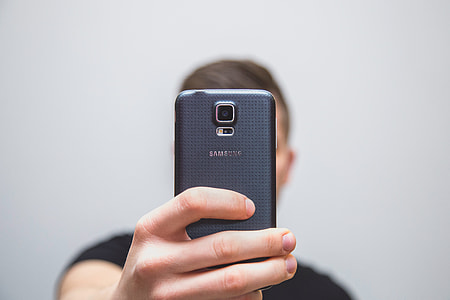 person holding black Samsung smartphone thumbnail