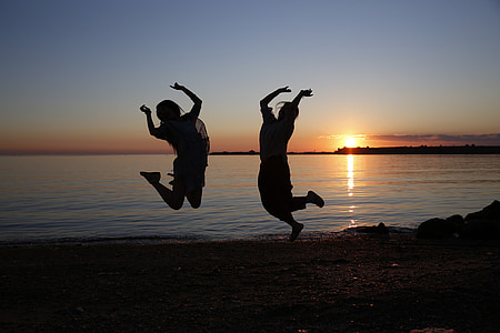 silhouette of two women doing jump shot thumbnail