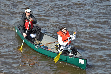 man and woman paddling on boat during daytime thumbnail