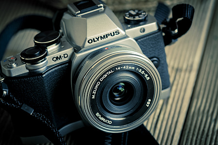 gray Olympus camera on surface\ thumbnail