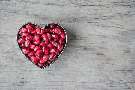 Silver Heart Bowl Filled of Red Pomegranate Seeds thumbnail