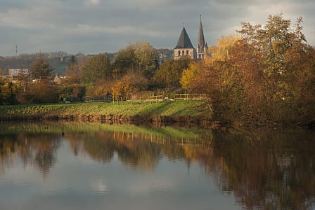 body of water near trees and grasses thumbnail