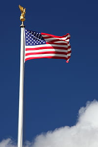 waving U.S.A flag on pole at daytime thumbnail