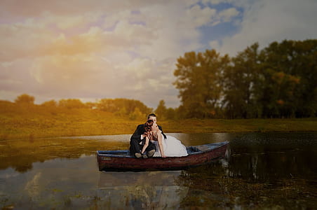 man and woman on brown wooden boat thumbnail