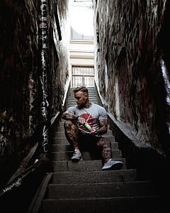 man sitting on concrete stairs thumbnail