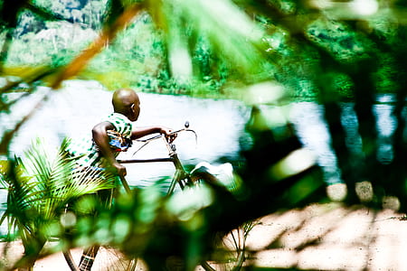 person holding bike near water thumbnail