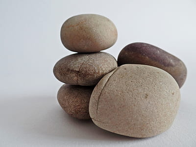 five stones on white surface thumbnail