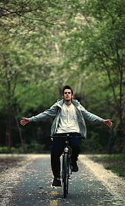 shallow focus photography of man riding on bicycle thumbnail