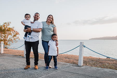 Man and Woman Standing Alongside With Their Children thumbnail