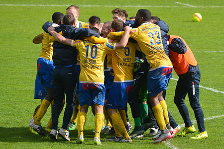 soccer team hugging on field thumbnail