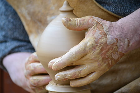 person making clay vase thumbnail