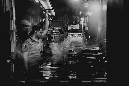grayscaled photo of man in kitchen thumbnail