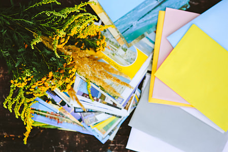 Yellow flowers with miscellaneous items on wooden floor thumbnail