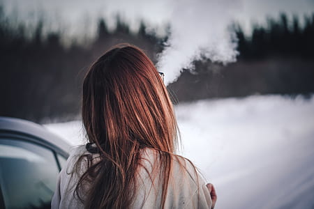 brown haired woman beside white car thumbnail