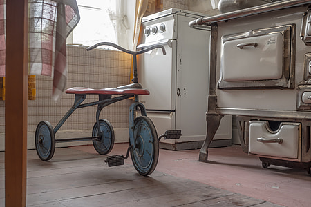 red and black trike beside gas range thumbnail