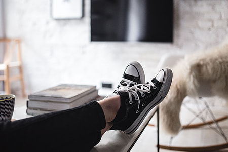 Young woman sitting on the sofa and working on her laptop thumbnail