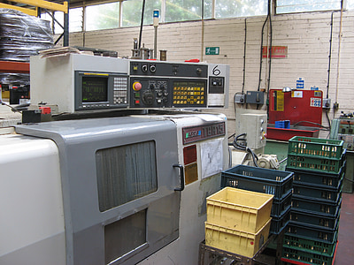 assorted-color plastic crate lot near white and gray metal industrial machine inside room thumbnail