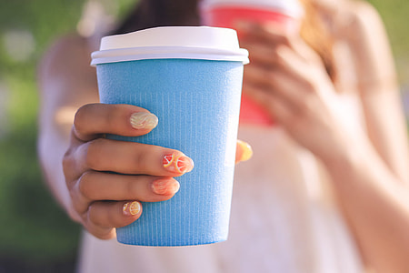 person holding blue disposable cup thumbnail