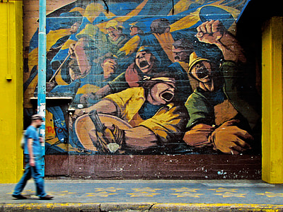man walking beside mural artwork thumbnail