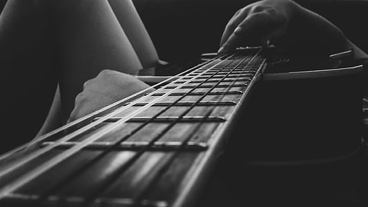 Person Holding an Acoustic Guitar thumbnail