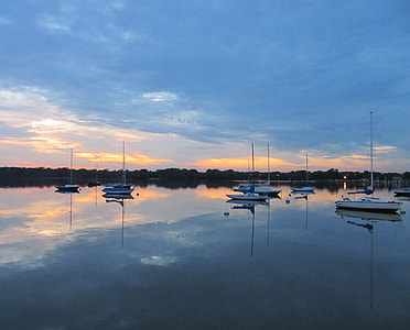 several white boats on calm body of water at daytime thumbnail
