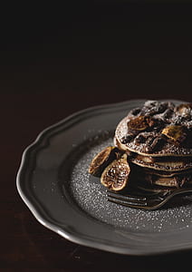 pancakes with nuts and white sugar placed on gray ceramic plate thumbnail
