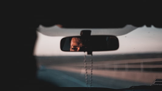 man's face viewed from vehicle rear view mirror thumbnail