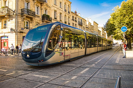 silver electric train in the middle of the street during daytime thumbnail