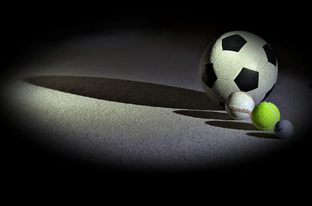 four balls on ground casting shadows thumbnail