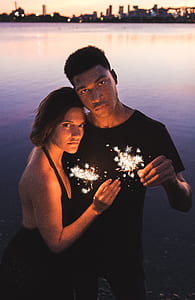 man and woman holding lights thumbnail