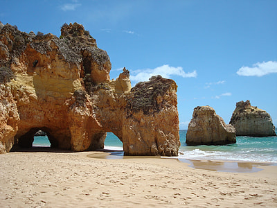 brown cliff near seashore during daytime thumbnail