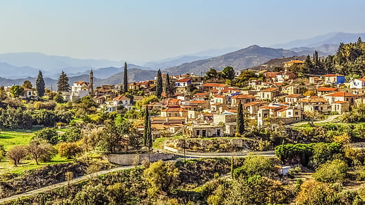 photo of beige buildings beside trees thumbnail