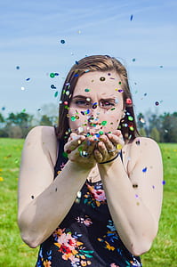 woman blow petals on her hands thumbnail