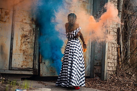 Woman Standing on Orange and Blue Smoke thumbnail