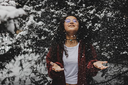 woman standing near snowed green leafed trees thumbnail