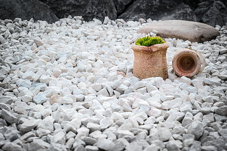 two brown plant pots on grey rocks thumbnail