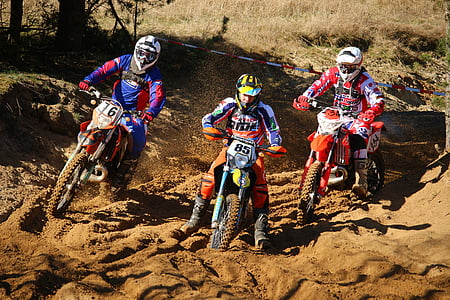 three people riding motocross dirt bikes thumbnail