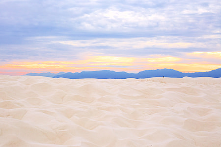 sand near mountain during daytime thumbnail