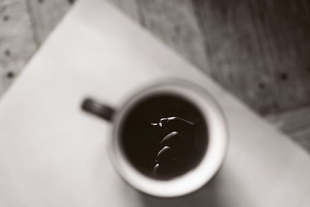 white mug filled with black liquid thumbnail