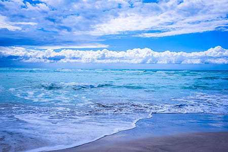Body of Water Under Blue and White Skies thumbnail