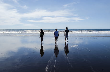 woman and two men on shoreline thumbnail