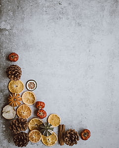 sliced fruit and pinecone on floor thumbnail
