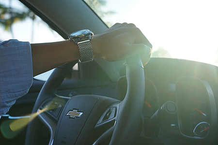 person driving Chevrolet car during daytime thumbnail