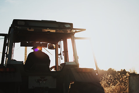 black tractor near brown field thumbnail