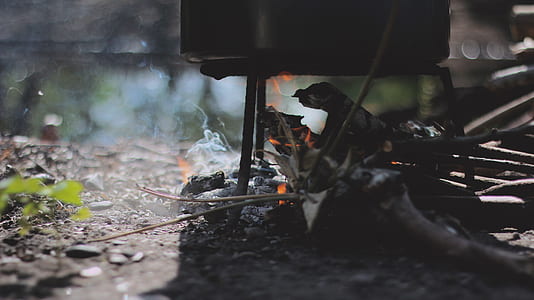 burning wood under cooking pot thumbnail